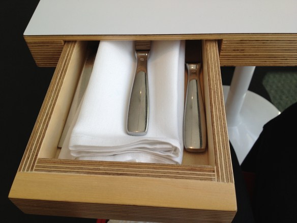At Ray's Restaurant at the LA County Museum of Art, the tables have little drawers. Inside them you'll find your napkin, fork and knife. Loved it!
